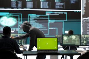 Isolated copy space running on a laptop in high tech agency office, governmental hackers analyzing digital threats on big screens. Working on cybercrime and protection against phishing. photo