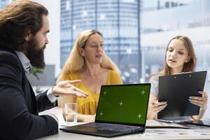 Financial advisor developing budget for family using isolated screen laptop, managing their expenses and savings. Agent helping clients, allocating income to investments using mockup notebook photo