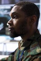 Military specialist monitors satellite data and integrates real time information, coordinates strategic missions. Supports decision making and national security in a sophisticated control center. photo