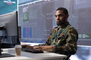 Military personnel in a high tech control center process critical information, examining real time surveillance data for security protocols essential to national defense strategic tactics. photo