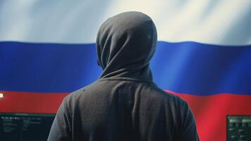 Expert in governmental hacking room with a Russian flag on big screen, individual in cyberwarfare and propaganda. Russian federation hacker works on sabotage and political manipulation. Camera B. photo