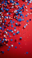 Red, white and blue confetti on a red background photo