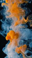 Orange and blue smoke in water photo