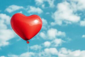 A red heart shaped balloon is floating in the sky photo