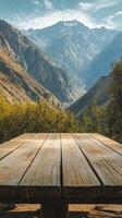 A wooden table in front of a mountain range photo
