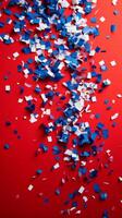Red, white and blue confetti on a red background photo