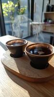 Two cups of coffee on a wooden tray photo