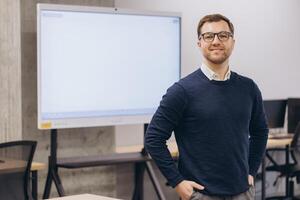 Business professional smiling confidently near interactive whiteboard, representing corporate leadership and modern workplace technology photo