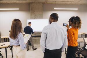 Diverse business team collaborating, brainstorming project details while presenting insights in modern office setting photo
