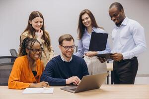 Professional team collaborating, utilizing digital tools for seamless workflow in modern, open plan office environment photo