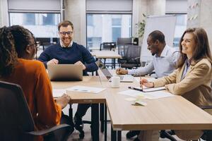 Professional team collaborating during strategic planning session, diverse colleagues brainstorming project details in modern workplace setting photo