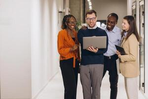 Diverse colleagues working together, sharing ideas and using technology to achieve common goals in a modern workplace photo