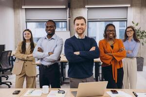 Professional colleagues standing confidently, displaying diverse team unity in modern office environment photo