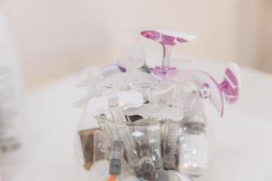 Medical syringes and sterile needles arranged neatly in glass container, preparing for aesthetic injection treatments photo
