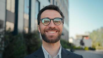 Happy business entrepreneur successful Caucasian businessman near office building outside male portrait smiling guy in spectacles outdoors joyful man CEO leader manager in city cheerful toothy smile photo