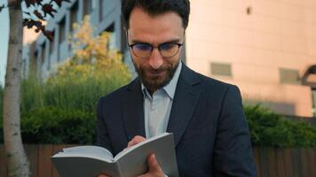 Thoughtful pensive man Caucasian businessman business coach in city write notes in notebook university professor writer thinking writing ideas at paper notepad smiling prepare for class lesson outside photo