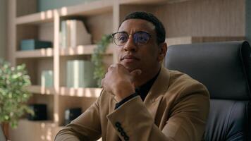 Close up thoughtful male businessman puzzled ethnic man think difficult question business problem solution at office workplace pensive employer manager CEO thinking ponder deep thoughts consider doubt photo