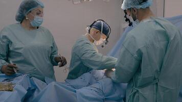 Surgeon with assisting man doctor operating patient perform surgical procedure. Nurse woman stand at table with medical instruments cut out appendicitis malignant tumor heart disease surgery process photo