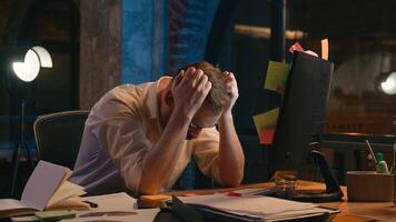 Stressed frustrated business man at night office overworked trouble problem businessman male guy looking at monitor screen sticky notes with writing many tasks on computer tired exhausted headache photo