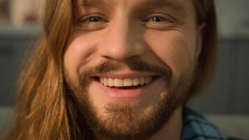 Close up Caucasian bearded man male guy sleeping napping relaxing leaning couch sofa wake up looking at camera smiling happy laughing smile positive face portrait laugh satisfied indoors joy fun funny photo