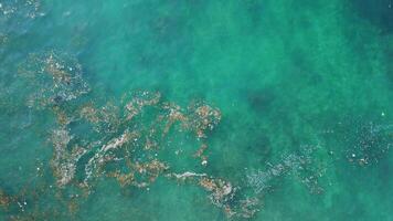 Ocean surface with floating plastic trash. Aerial view of plastic pollution in Bali video