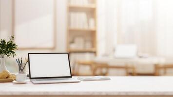 A laptop on a tabletop with a blurred background of a comfortable, minimalist room. photo