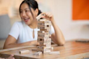 A close-up of a Jenga tower or wooden blocks stack on a coffee table in the living room. photo