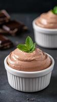 Creamy chocolate mousse topped with fresh mint in white ramekin photo