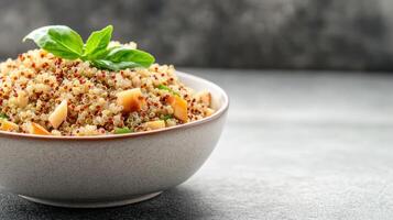 Fresh quinoa salad with apples and basil in ceramic bowl photo