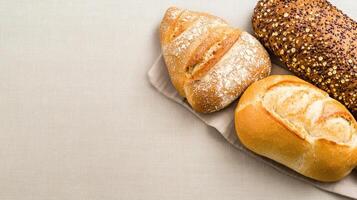 Fresh whole grain bread varieties on linen cloth, showcasing texture and color photo