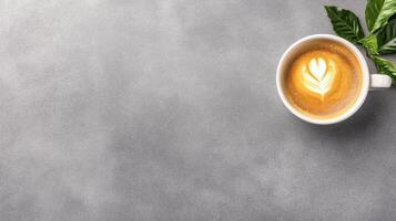 warm cup of espresso with golden crema and latte art on gray surface photo