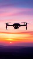modern drone hovering in mid air against colorful sunset sky photo
