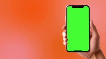 Animated of a person's hand holding a smartphone with a green screen, ideal for editing or using chroma key in videos on a orange background