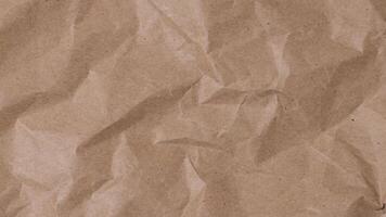 Crumpled brown paper stop motion animation, Textured paper background. The concept of sketch pad, design, retro style, wrinkle, frayed, blank video