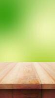 Empty wooden table with green blur vertical background looping for display product reels aor stories instagram video