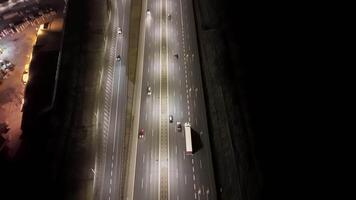 Aerial view of illuminated highway at night, Cars driving on a multi-lane highway at night, top view video
