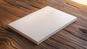 White card with a blank space sits on a wooden table. photo