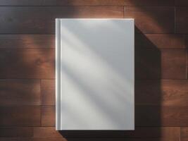 High Definition View of Blank White Book Cover on Brown Wooden Floor Mock Up photo