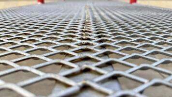 Metal Mesh Texture Close-up view of a metallic expanded metal mesh, showcasing its intricate diamond pattern and industrial aesthetic. photo