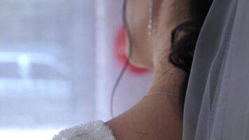 Detailed view of a girl's face hidden behind a veil, showing the intricate textures and patterns of the fabric video