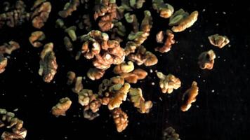 Slow Motion Walnuts Falling Against a Dark Background in a Studio Setting video