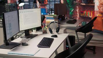 PC in startup office used to design and implement algorithms enabling machine learning. Technology unicorn venture workspace with PC used to conduct code reviews to fix bugs, jib down shot video