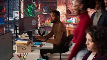 Startup company back end developer fixing applications issues, dealing with databases and server configuration. Man in office optimizing software for improved performance and scalability, camera A video