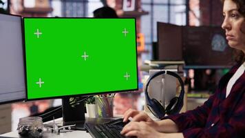 Computer scientist using green screen PC working with artificial intelligence technology in tech startup. Chroma key computer monitor used by IT specialist developing AI systems in office, close up video