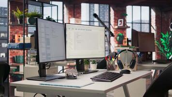 Empty startup office with PC on desk to be used by programmers building scalable solutions for businesses. AI industry startup workspace leveraging machine learning technology video