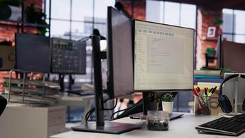 Advanced AI algorithms running on computer monitors in empty startup workspace deploying machine learning models. Coding platform on PC screens in Silicon Valley office, close up shot video