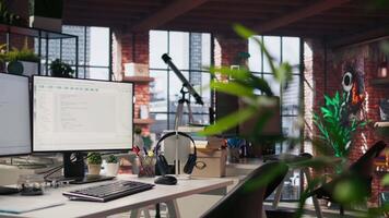Empty AI industry startup workplace leveraging machine learning technology. Company office with PC on desk to be used by programmers building scalable solutions for businesses, trucking left shot video