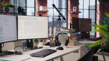 Advanced AI algorithms running on computer monitors in empty startup workspace deploying machine learning models. Coding platform on PC screens in Silicon Valley office, trucking left shot video