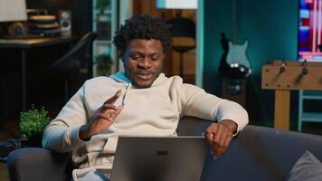 Male remote worker smiling during a virtual meeting with his trainer, showcasing effectiveness of online tools and internet connection. Person starting training session for the new job. Camera A. video