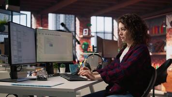 Startup cybersecurity expert looking for company security vulnerabilities on computer monitors. Software development agency programmer installing fortified code on PC, camera A video